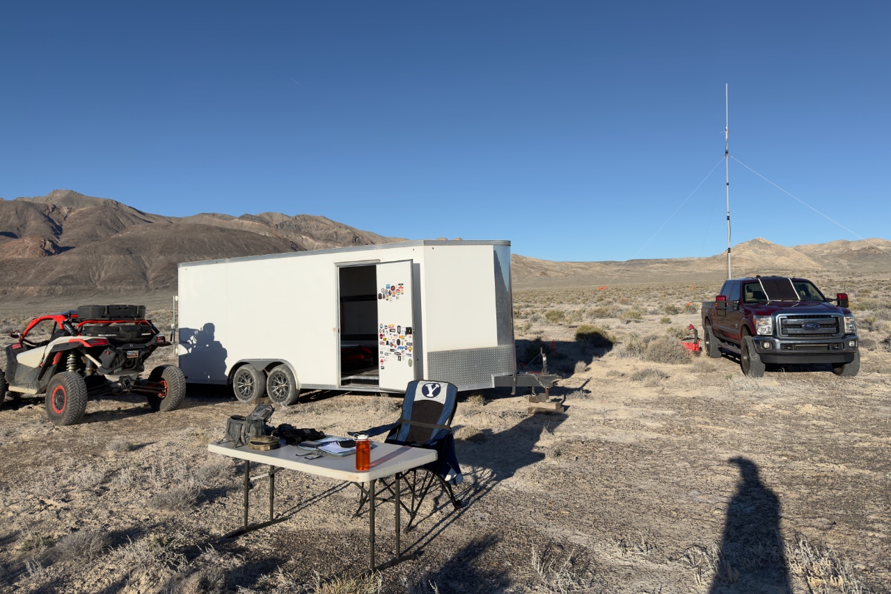 Radio setup for Aid Station 1: truck, trailer, side by side, antenna mast, radios, table, and chair